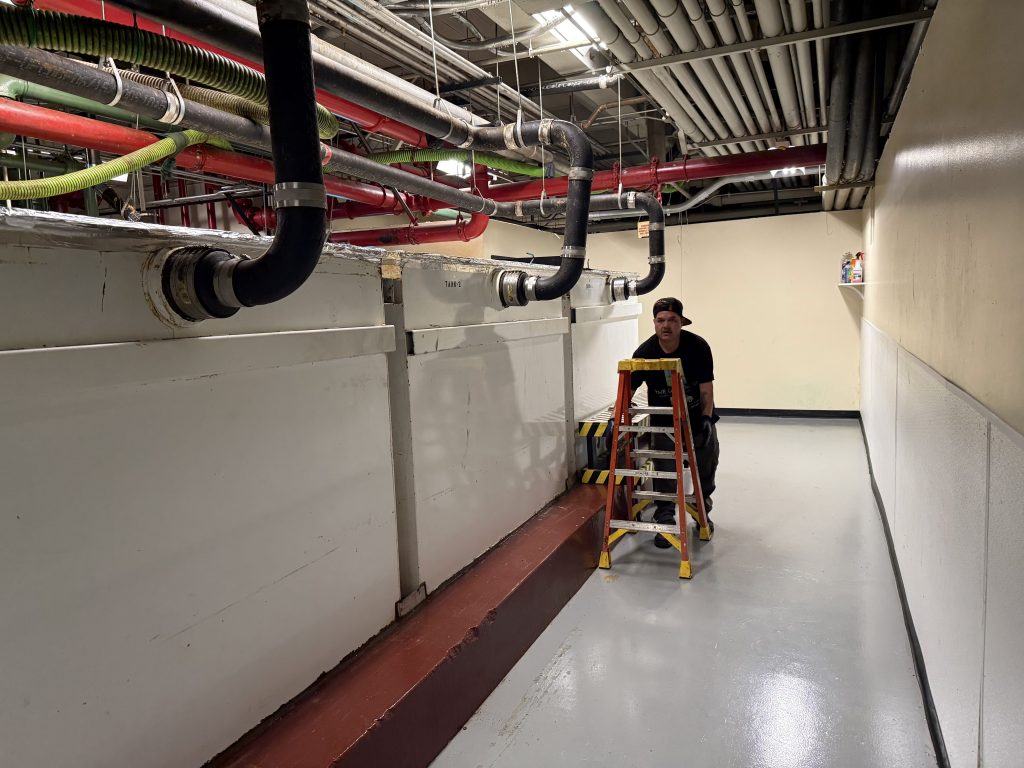 Technicians performing professional grease interceptor cleaning for San Diego commercial kitchen
