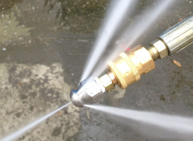 Hydro jetting equipment unclogging a blocked commercial kitchen drain