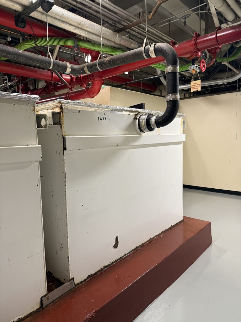 Large commercial grease interceptor installed in a parking lot for high-volume kitchen waste