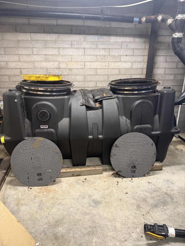 Underground grease interceptor installed for commercial kitchen waste management in San Diego