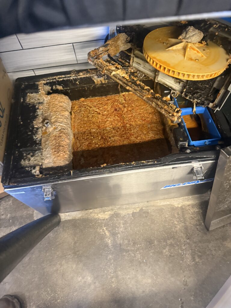 San Diego grease trap cleaning in progress inside commercial kitchen